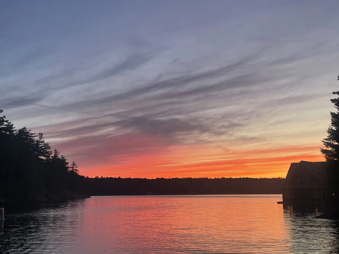 Sunset looking out over Hamer Bay from Sterling Point, the sky orange over the far shore